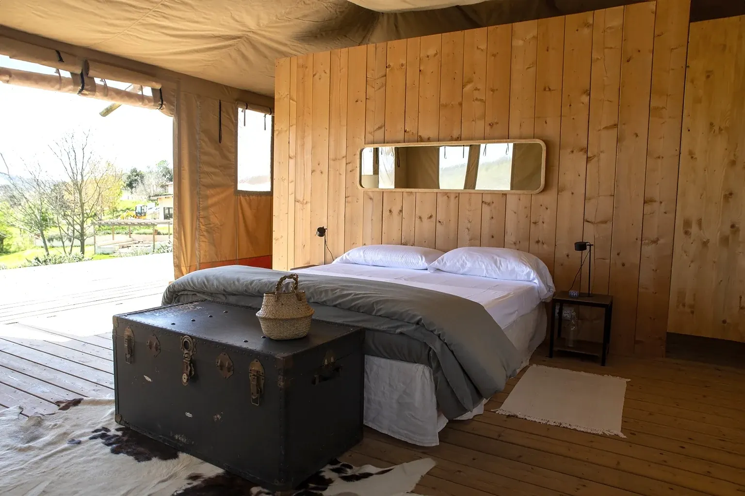 Lodge interior with double bed and wooden walls